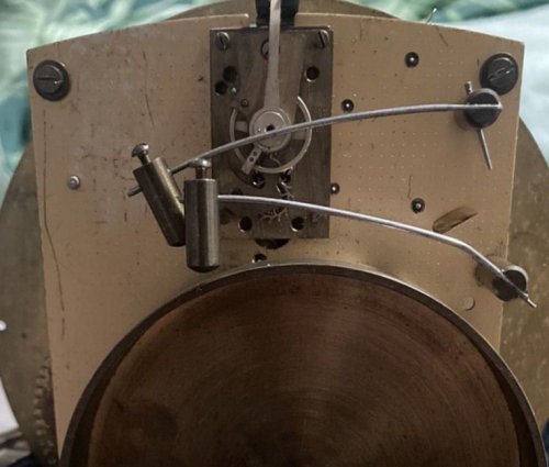 Smiths clock with a balance wheel rotating on a vertical plane
